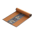Chemin de table en bambou terracotta roulé, bandeau brodé gris ardoise à pin doré