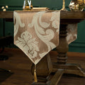 Chemin de table jacquard beige — pointe et pompon doré