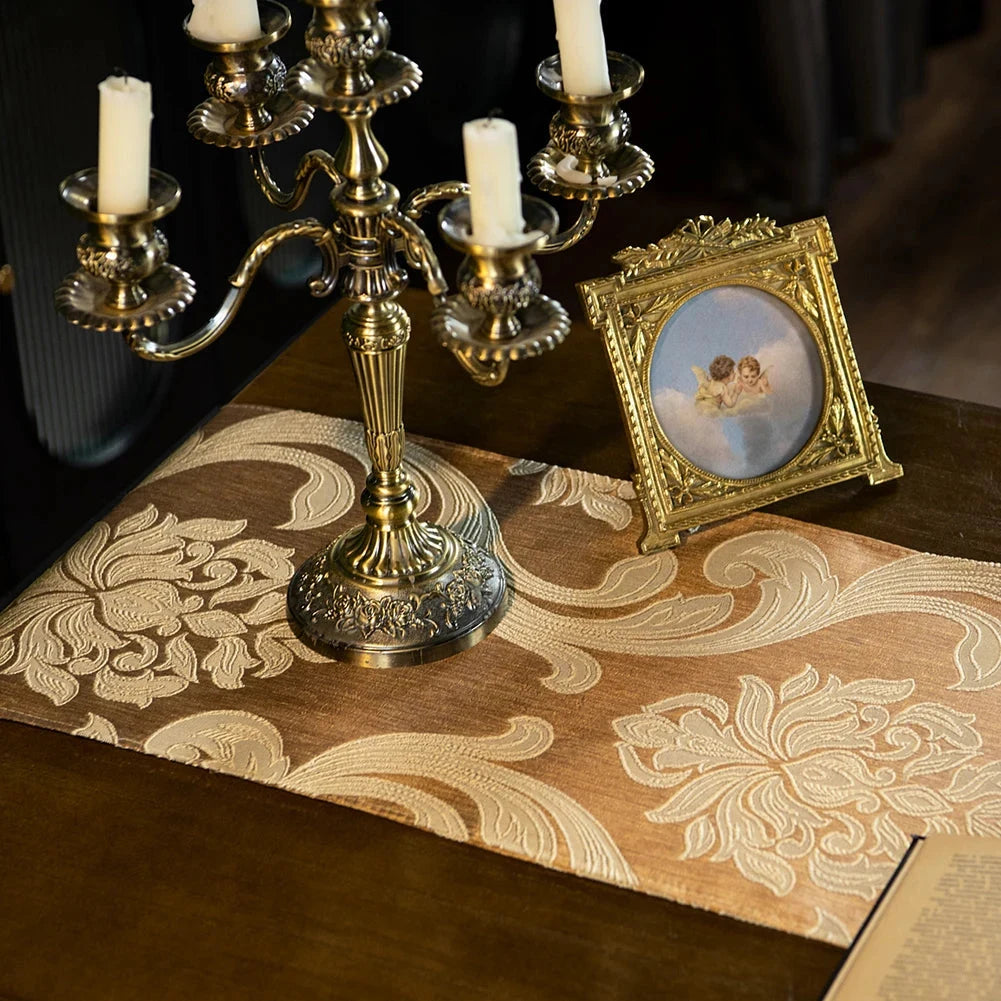Chemin de table jacquard beige sous un chandelier — ambiance classique