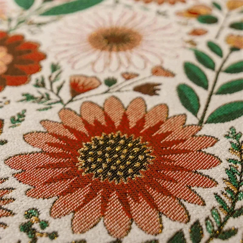 Détail du tissage jacquard fleurs orange — gros plan sur les motifs